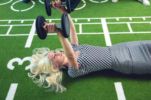 a woman laying on the ground holding onto a bar at Pestana CR7 Gran Vía Madrid in Madrid