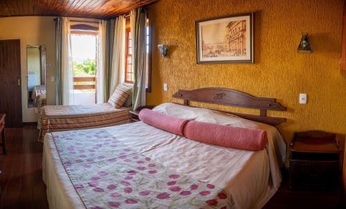 Ein Bett oder Betten in einem Zimmer der Unterkunft Pousada dos Pireneus