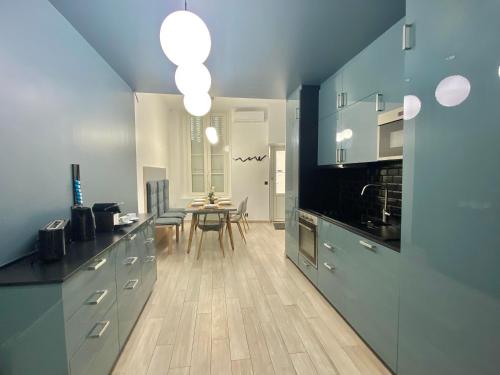 a kitchen with a table and a dining room at Appartement République in Paris