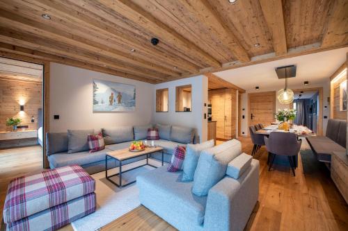 a living room with a couch and a table at Brunnenhof Luxury Apartments in Lech am Arlberg