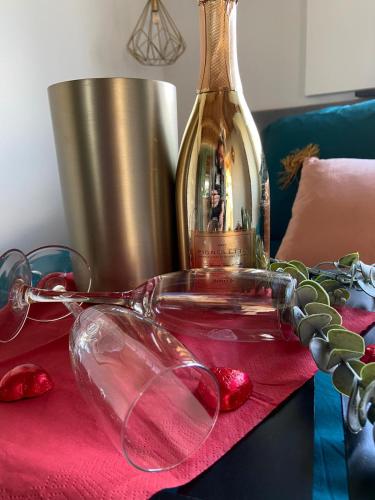 a bottle of wine and glasses on a table at Noxem b&b in Boesingheliede