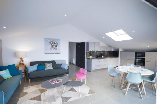 a living room with a couch and a table and chairs at Appartement Mont Blanc - Vue Lac in Sévrier