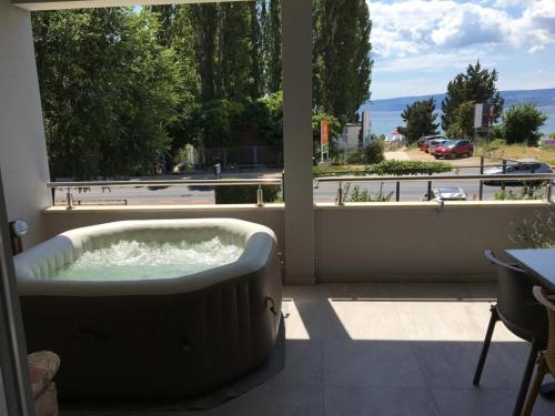 a bath tub in a room with a large window at Apartments Ante in Omiš