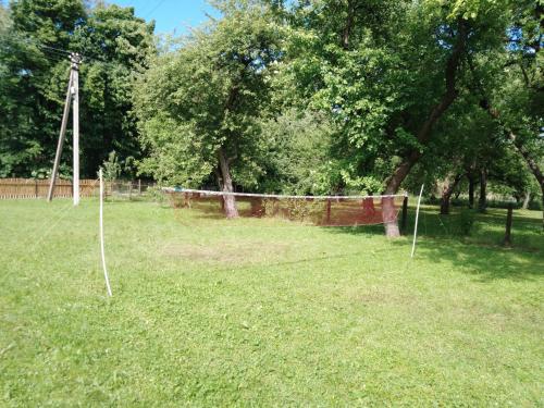 a net in a field with trees and grass at ЗАТИШОК in Oriv