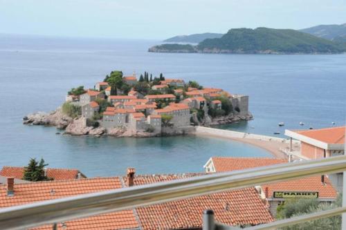 a small island in the middle of a body of water at BMV room 2 with east island view in Sveti Stefan