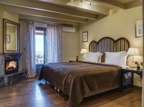a bedroom with a large bed and a fireplace at Aegli Arachova in Arachova