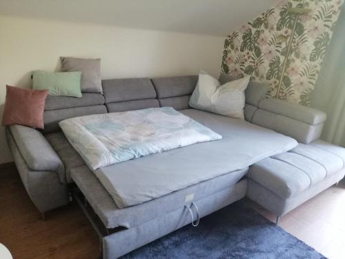 a couch with a bed on top of it at Fewo Fabiella mit Balkon in Millstatt