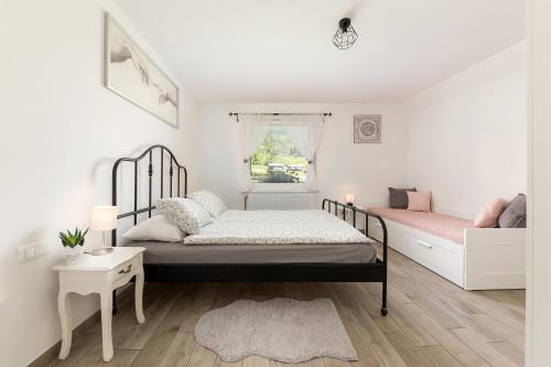 a bedroom with two beds and a window at Pod Koblo Bohinj Apartments in Bohinj