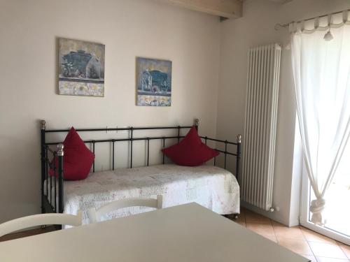 a bedroom with a bed with red pillows on it at Agriturismo Maso Bergot in Arco