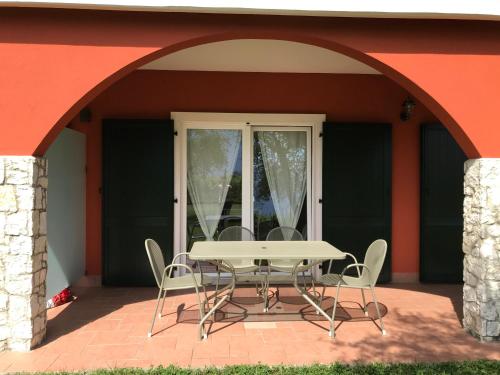 a table and chairs in front of a house at Agriturismo Maso Bergot in Arco