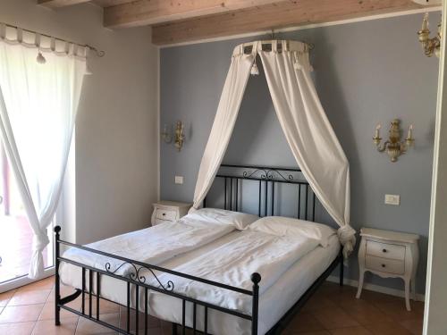 a bedroom with a bed with a canopy at Agriturismo Maso Bergot in Arco