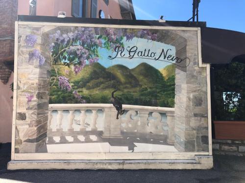 a sign on the side of a building with flowers at Holiday Home Vista Lago in Cernobbio