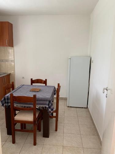a kitchen with a table and chairs and a refrigerator at Anita Guest House in Tivat