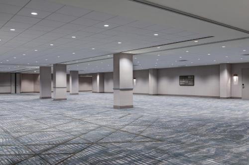 a large room with pillars in a building at Hyatt Regency DFW International Airport in Dallas