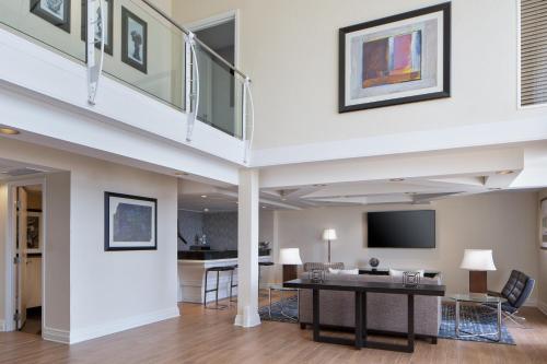 a living room with a table and a tv at Hyatt Regency DFW International Airport in Dallas