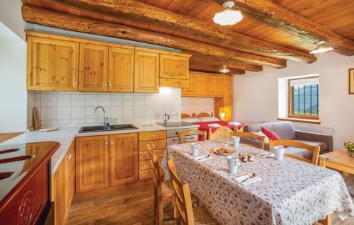 a kitchen and dining room with a table and chairs at Albergo Diffuso Ravascletto in Ravascletto