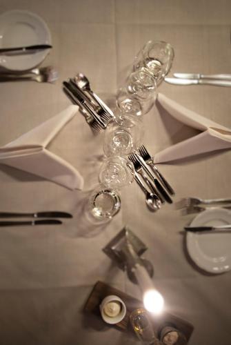 a table with wine glasses and silver utensils at Åkerblads Hotell Gästgiveri Spa in Tällberg