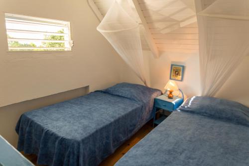 En eller flere senge i et værelse på Les Jardins de l'Espérance