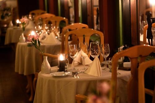 a table with wine glasses and candles on it at Åkerblads Hotell Gästgiveri Spa in Tällberg
