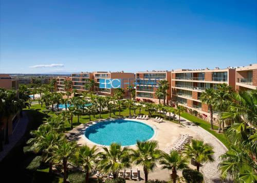an aerial view of a resort with a pool and palm trees at Apartments Herdade dos Salgados by PCFerias in Albufeira