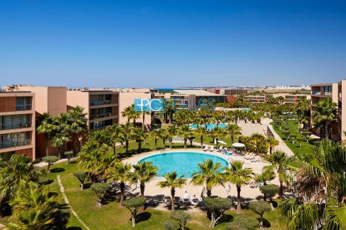 an aerial view of a resort with a pool and palm trees at Apartments Herdade dos Salgados by PCFerias in Albufeira