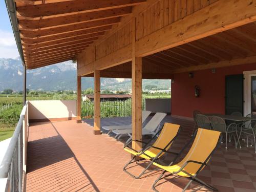 a patio with two chairs and a table on it at Agriturismo Maso Bergot in Arco