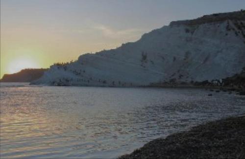 a large body of water next to a mountain at Villa Azzurra Scale of the Turks in Realmonte