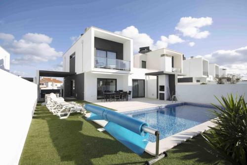 a house with a pool and a water slide at Deluxe Villa - By SCH in Salir de Porto