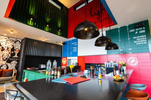 a bar in a restaurant with pink and green walls at lyf Tenjin Fukuoka in Fukuoka