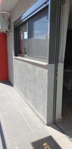a window on the side of a building at AVR Airport Deluxe Suites 6 AIRPORT FREE SHUTLE in Markopoulo