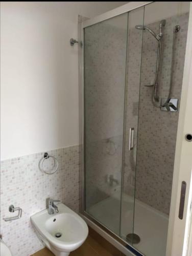 a bathroom with a glass shower and a sink at Villa Azzurra Scale of the Turks in Realmonte
