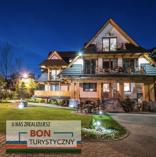 a house with a sign in front of it at Willa Ryś in Zakopane