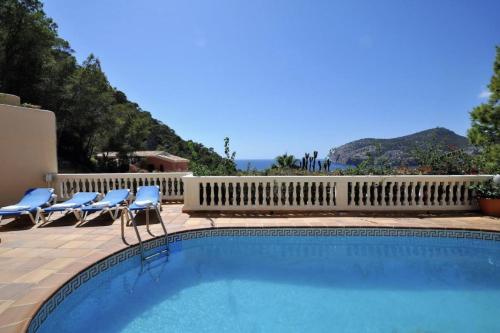 a swimming pool with chairs and a view of the ocean at Villa Camp de Mar, Sea View in Camp de Mar