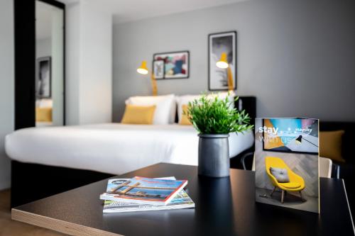 a hotel room with a bed and a table with a table sidx sidx at Staycity Aparthotels Bordeaux City Centre in Bordeaux