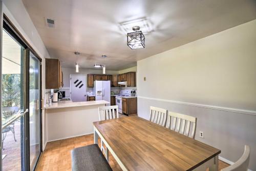a kitchen and dining room with a wooden table and chairs at Bluefield Retreat with Pool Table Near Parks! in Bluefield