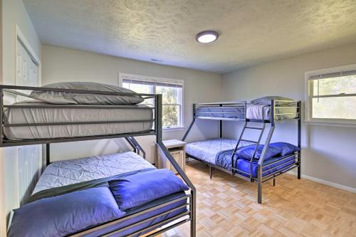 a room with three bunk beds and a window at Bluefield Retreat with Pool Table Near Parks! in Bluefield