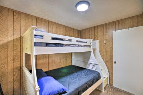 two bunk beds in a room with wooden walls at Bluefield Retreat with Pool Table Near Parks! in Bluefield