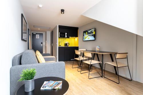 a living room with a couch and a table at Staycity Aparthotels Bordeaux City Centre in Bordeaux