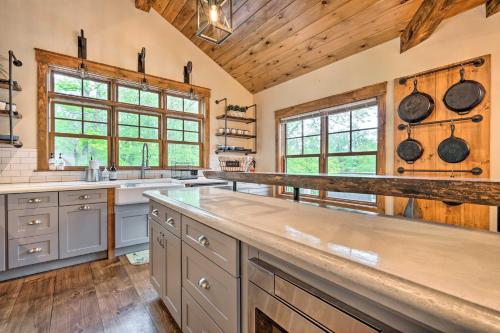 a large kitchen with wooden ceilings and wooden counters at Elegant Mtn Chalet with Deck 1 Mi to Mt Snow! in Dover
