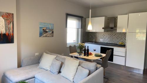 a living room with a couch and a table at Apartmani Žužić in Poreč