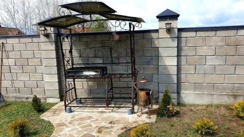 a brick wall with an outdoor grill in a yard at Садиба For Rest in Svityazʼ