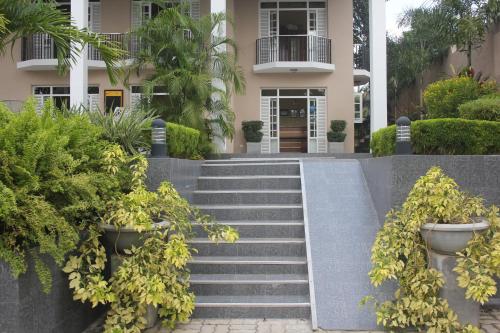 a building with stairs and plants in front of it at Grand 7 Hotel Thalawathugoda in Talawatugoda