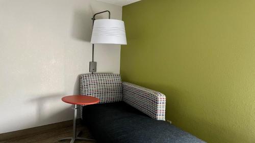 a room with a chair with a lamp and a table at Holiday Inn Express Middlesboro by IHG in Middlesboro