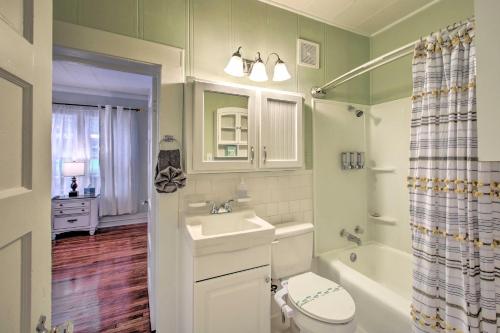 a bathroom with a sink and a toilet and a tub at half Mi to Hot Springs Natl Park Cottage with Patio in Hot Springs