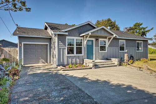 a gray house with a garage at Coastal Getaway by Pebble Beach and Redwoods! in Crescent City