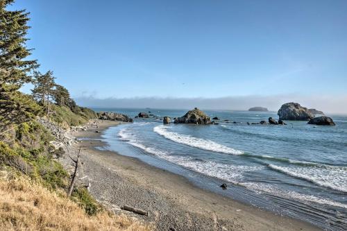 a sandy beach with rocks in the water at Coastal Getaway by Pebble Beach and Redwoods! in Crescent City