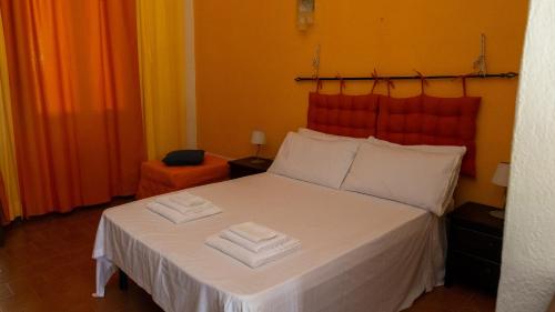 a bedroom with a bed with two towels on it at La Casa di Elisabetta in Agrustos