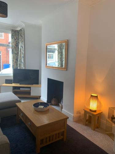 a living room with a couch and a coffee table at Hideaway House in Bridlington