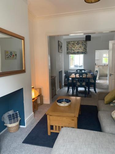 a living room with a couch and a table at Hideaway House in Bridlington