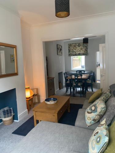 a living room with a couch and a table at Hideaway House in Bridlington
